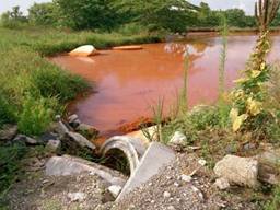 Mine drainage pond in Tar Creek made orange by iron oxide. Photo by Vaughn Wascovich.