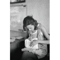 Photo of woman looking through papers.