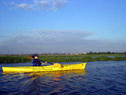 Photo shows woman in Riverkeeper kayak on the Hackensack River.