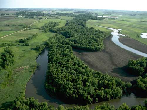 Photograph of a river and its surrounding landscape/watershed.
