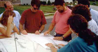 photo of a group of people going over plans